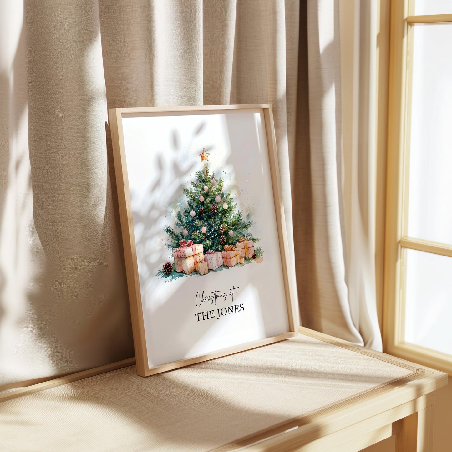 Watercolour Christmas tree decorated with gold star, pinecones, and pink baubles surrounded by wrapped gifts in soft festive tones. Customisable family name text reads “Christmas at The Jacksons.” Elegant personalised holiday wall art perfect for festive home décor or a thoughtful family Christmas gift. Printed to order on premium satin paper by Hues & Reflections UK.