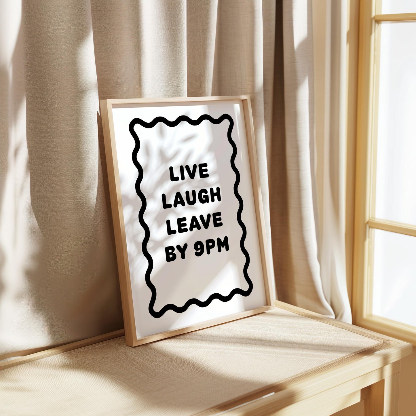 Bold black and white typography poster featuring the phrase “Live Laugh Leave By 9pm” framed by a wavy border. Minimalist modern design perfect for living rooms, hallways, or home offices. Funny quote wall art ideal for introverts, humour lovers, or as a witty gift for friends. Printed on premium satin paper, made in the UK by Hues & Reflections.