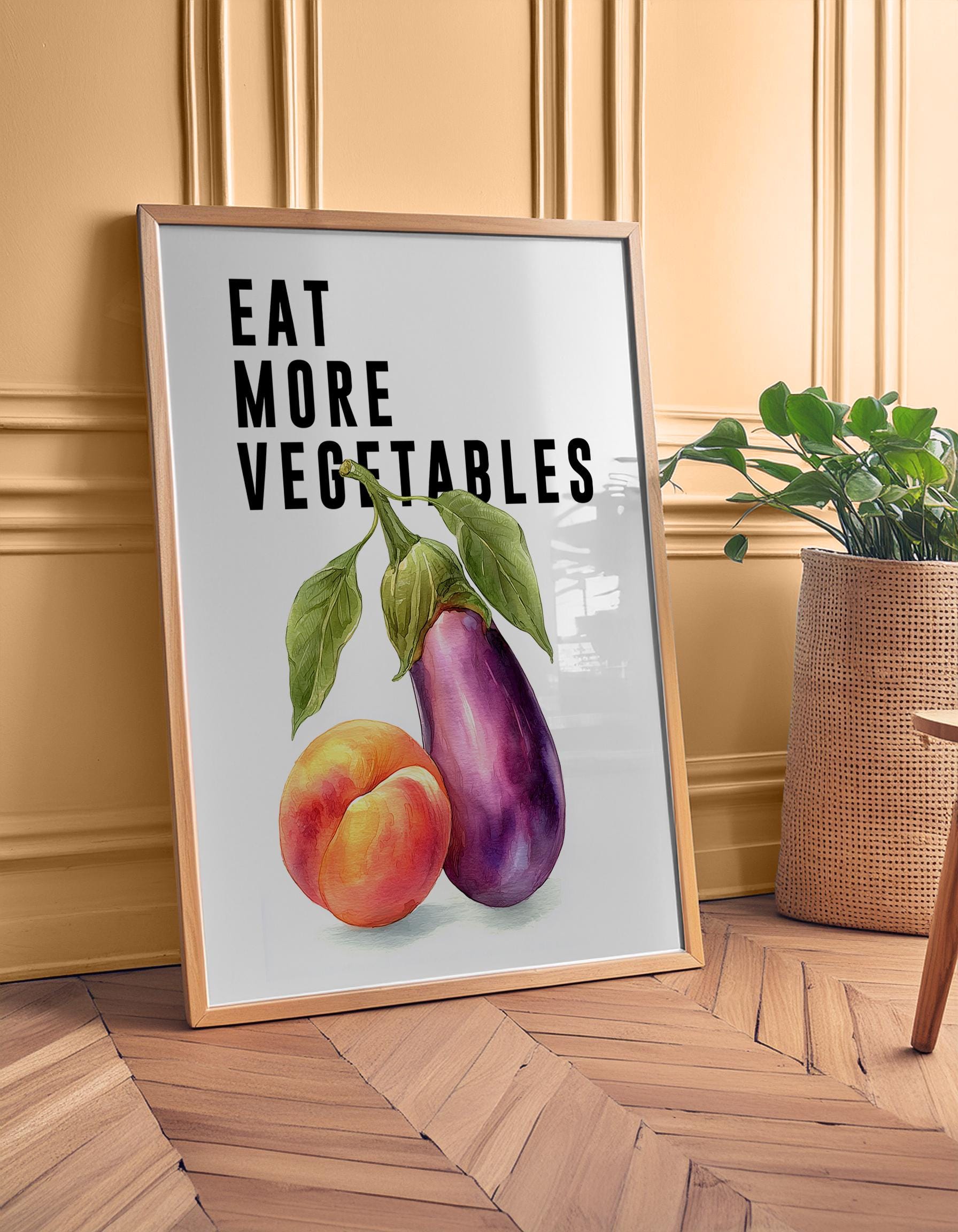 Playful food-themed wall art featuring bold black typography reading “Eat More Vegetable” above a colourful illustration of an aubergine and peach. Modern humorous kitchen poster with a cheeky twist, perfect for kitchens, dining rooms, or as a fun gift for friends. Printed to order on premium satin photo paper by Hues & Reflections UK.