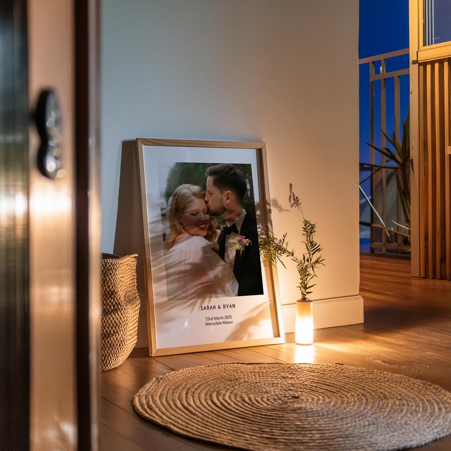 A personalised wedding photo print featuring a couple on their wedding day in elegant natural light. The bride wears an off-shoulder white gown and holds a soft green and white bouquet while the groom embraces her. Minimal modern layout with names, wedding date and venue below the image. A stylish custom keepsake for couples, weddings, anniversaries or home decor.