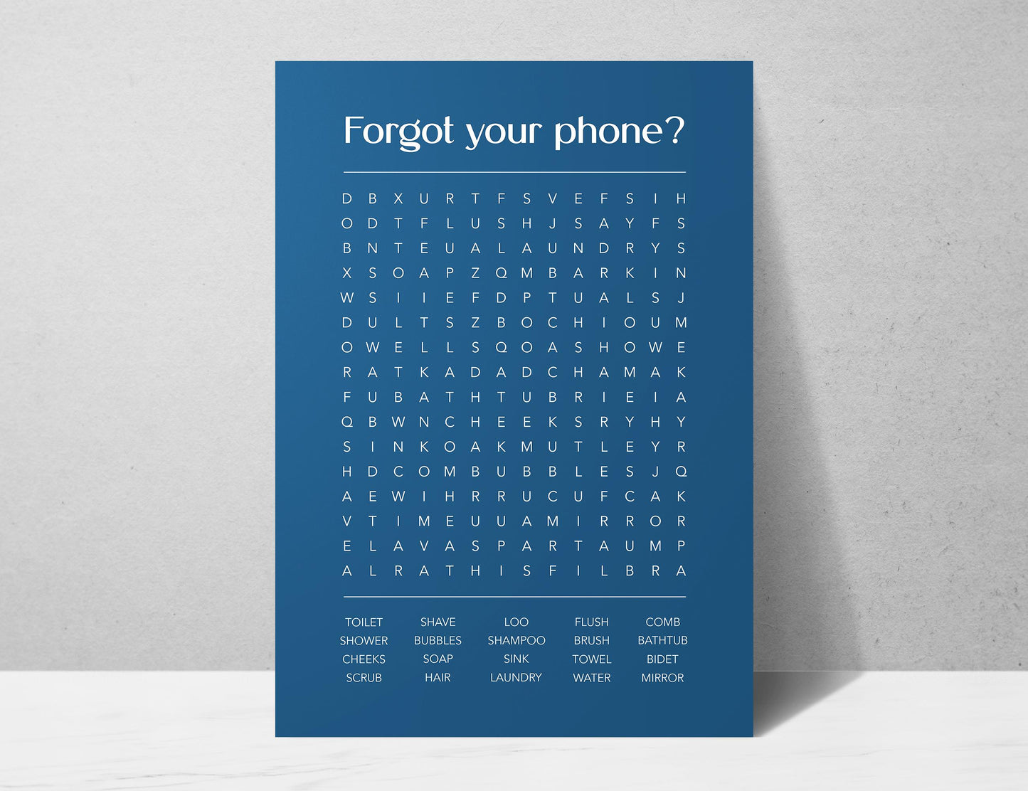 Funny bathroom word search print with the title Forgot Your Phone, modern typographic puzzle wall art featuring hidden bathroom themed words including shower bubbles bidet flush and comb, quirky toilet humour poster available in 8 colours including beige black and white blonde claret forest indigo lobster and olive, perfect for guest bathrooms powder rooms and as a housewarming gift, printed on premium 260gsm satin lustre paper, handmade in the UK by Hues and Reflections small business