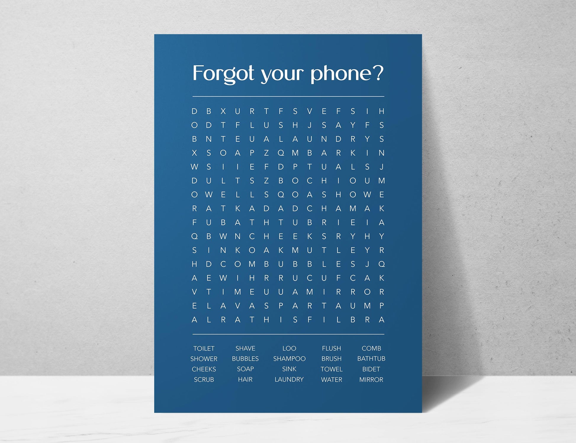 Funny bathroom word search print with the title Forgot Your Phone, modern typographic puzzle wall art featuring hidden bathroom themed words including shower bubbles bidet flush and comb, quirky toilet humour poster available in 8 colours including beige black and white blonde claret forest indigo lobster and olive, perfect for guest bathrooms powder rooms and as a housewarming gift, printed on premium 260gsm satin lustre paper, handmade in the UK by Hues and Reflections small business