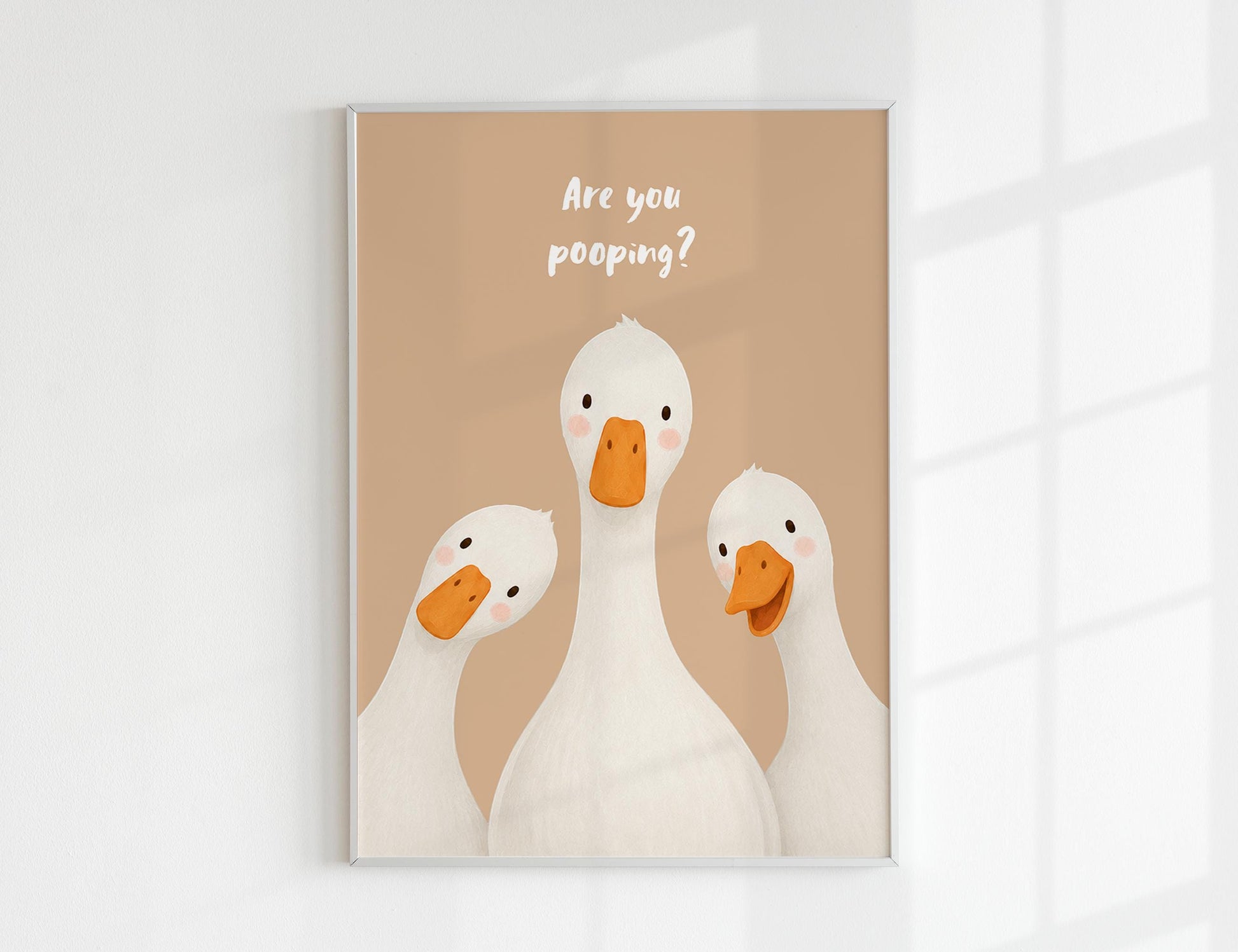 Are You Pooping print, funny bathroom wall art featuring three cute white geese with orange beaks and rosy cheeks on a soft coloured background, whimsical illustrated toilet humour poster also loved as duck art and silly goose art, available in 11 colours including pink jade olive yellow forest green blue sky blonde blue dusk grey claret indigo and white, perfect housewarming gift for powder rooms guest bathrooms and quirky interiors, printed on premium 260gsm satin lustre paper