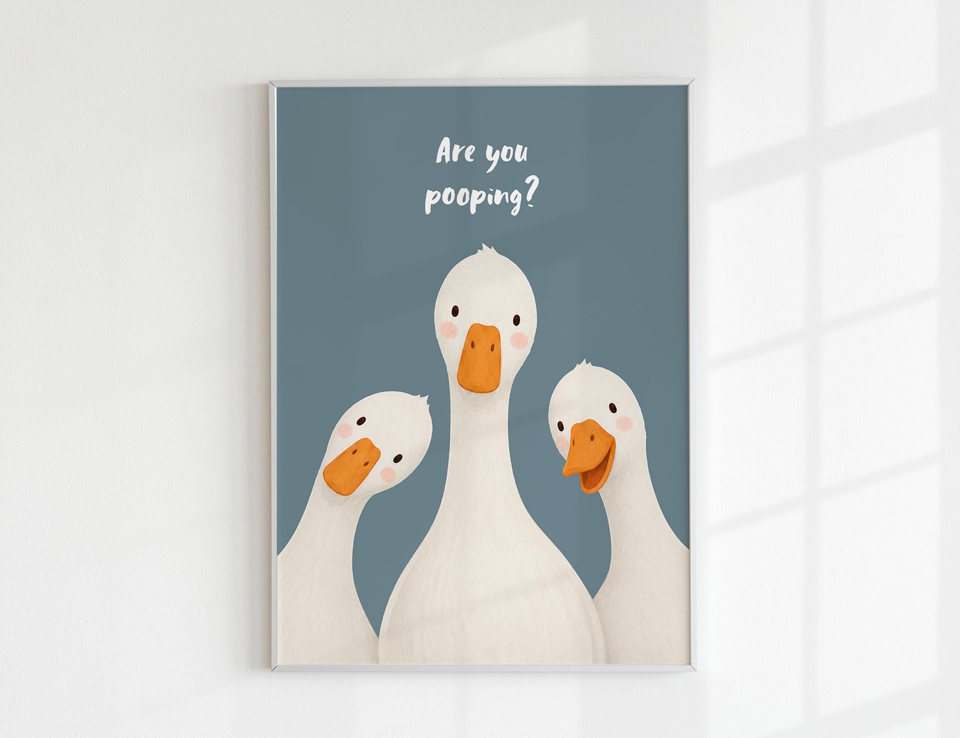 Are You Pooping print, funny bathroom wall art featuring three cute white geese with orange beaks and rosy cheeks on a soft coloured background, whimsical illustrated toilet humour poster also loved as duck art and silly goose art, available in 11 colours including pink jade olive yellow forest green blue sky blonde blue dusk grey claret indigo and white, perfect housewarming gift for powder rooms guest bathrooms and quirky interiors, printed on premium 260gsm satin lustre paper
