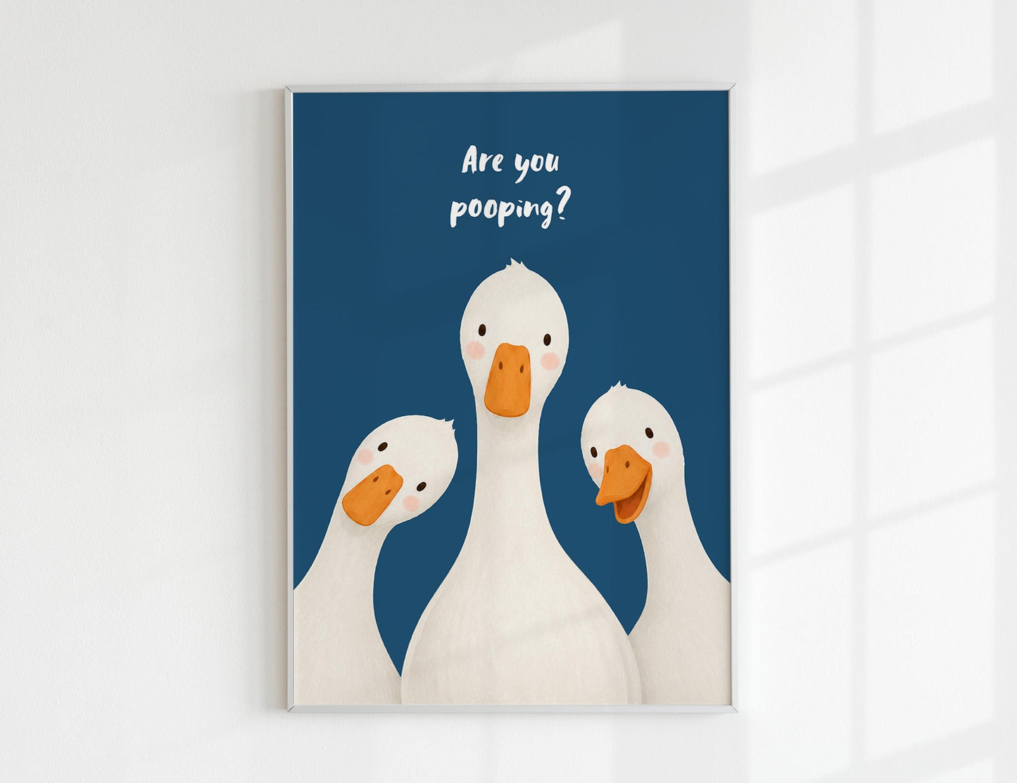 Are You Pooping print, funny bathroom wall art featuring three cute white geese with orange beaks and rosy cheeks on a soft coloured background, whimsical illustrated toilet humour poster also loved as duck art and silly goose art, available in 11 colours including pink jade olive yellow forest green blue sky blonde blue dusk grey claret indigo and white, perfect housewarming gift for powder rooms guest bathrooms and quirky interiors, printed on premium 260gsm satin lustre paper
