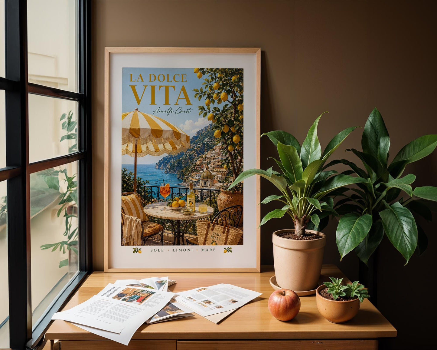 La Dolce Vita Amalfi Coast poster featuring a sunny Italian balcony with yellow and white striped umbrella, marble bistro table with Aperol spritz and Limoncello, lemon tree and view of Positano coastline, vintage Italian travel poster style wall art in warm golden palette, perfect Mediterranean print for kitchens dining rooms and Italy lovers, printed on premium 260gsm satin lustre paper, handmade in the UK by Hues and Reflections small business