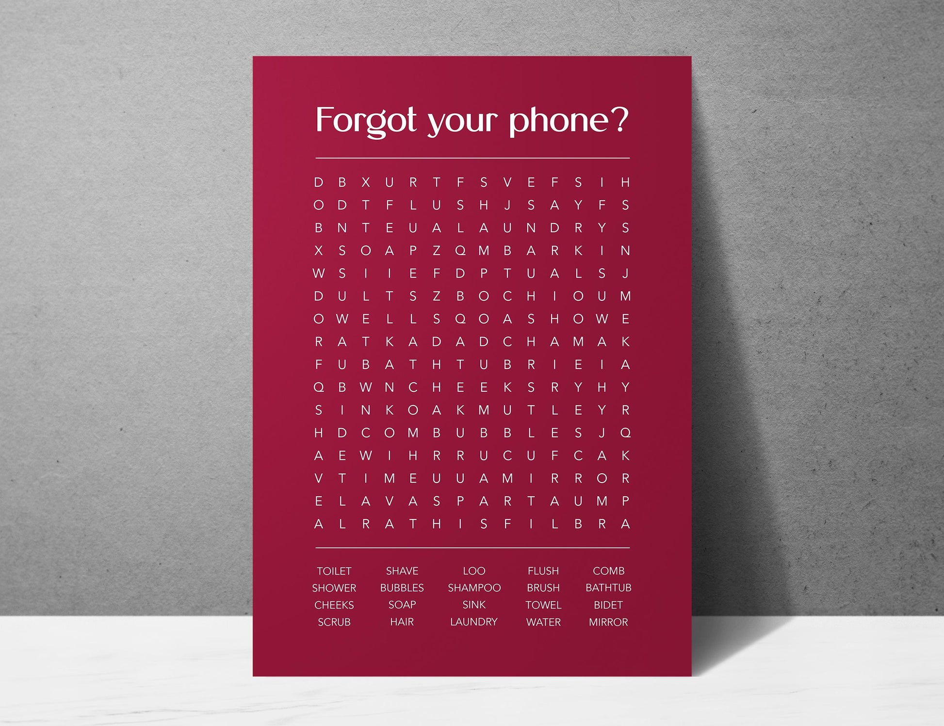 Funny bathroom word search print with the title Forgot Your Phone, modern typographic puzzle wall art featuring hidden bathroom themed words including shower bubbles bidet flush and comb, quirky toilet humour poster available in 8 colours including beige black and white blonde claret forest indigo lobster and olive, perfect for guest bathrooms powder rooms and as a housewarming gift, printed on premium 260gsm satin lustre paper, handmade in the UK by Hues and Reflections small business
