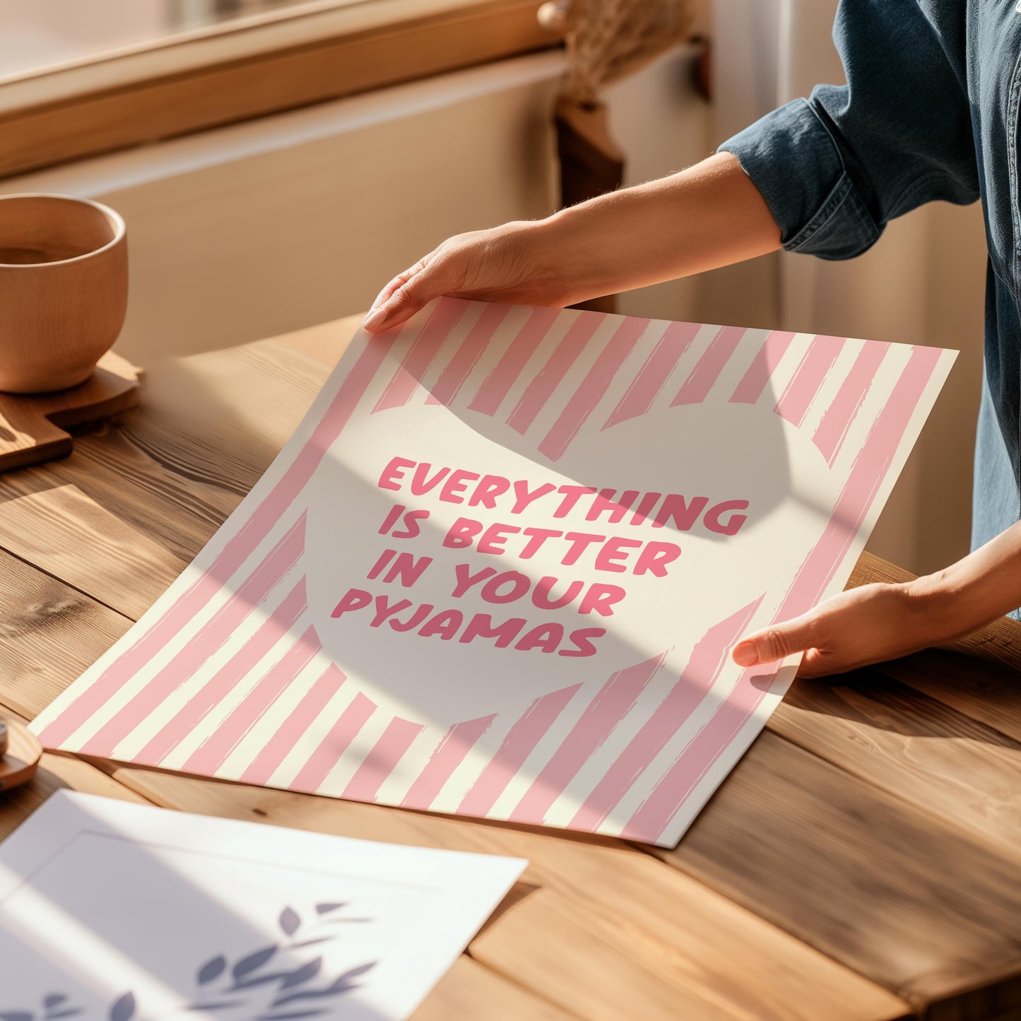 Everything Is Better In Your Pyjamas print, funny pink bedroom wall art featuring a chunky hand drawn quote inside a cream heart on a pink hand painted stripe background, cute cosy bedroom decor poster for above the bed dressing rooms walk in wardrobes and girly interior schemes, perfect thoughtful gift for best friends sisters bridesmaids hen dos Galentines Mother's Day and housewarming, printed on premium 260gsm satin lustre paper, handmade in the UK by Hues and Reflections small business