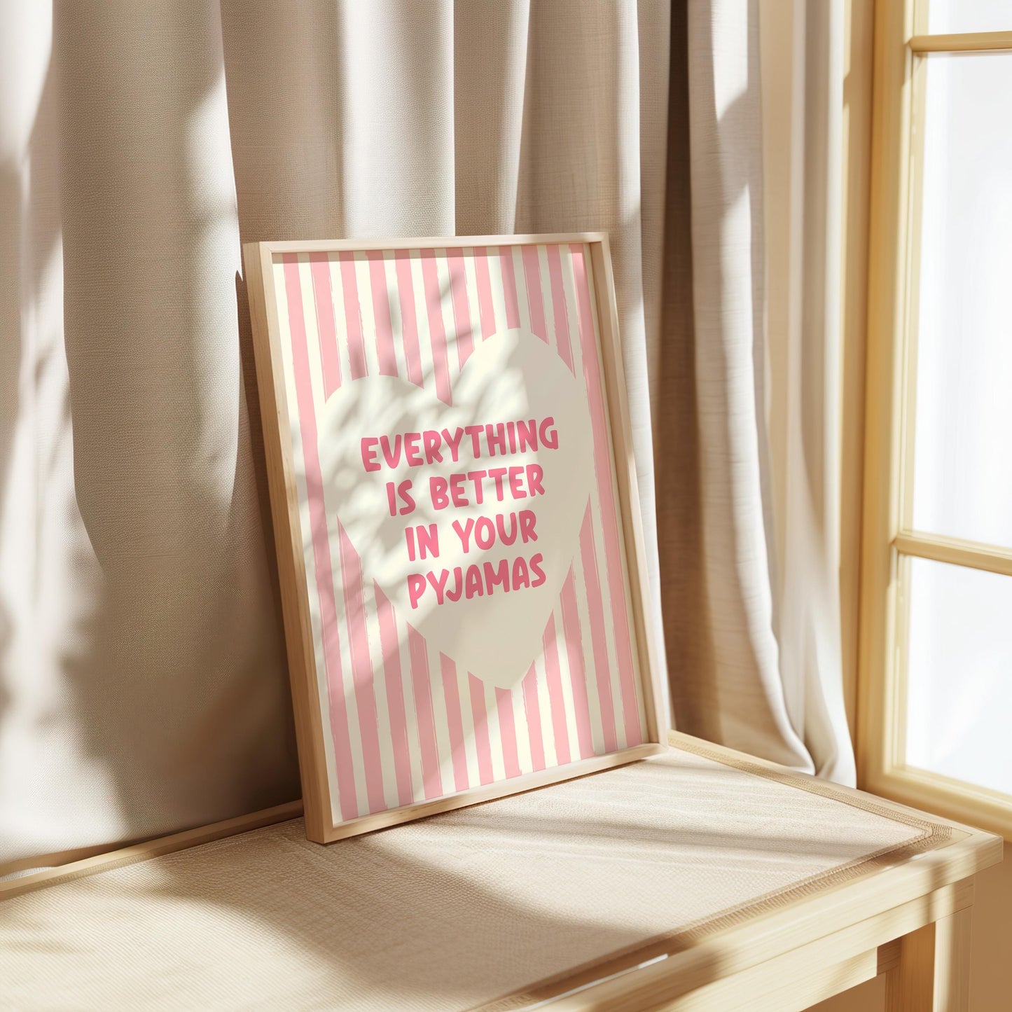 Everything Is Better In Your Pyjamas print, funny pink bedroom wall art featuring a chunky hand drawn quote inside a cream heart on a pink hand painted stripe background, cute cosy bedroom decor poster for above the bed dressing rooms walk in wardrobes and girly interior schemes, perfect thoughtful gift for best friends sisters bridesmaids hen dos Galentines Mother's Day and housewarming, printed on premium 260gsm satin lustre paper, handmade in the UK by Hues and Reflections small business