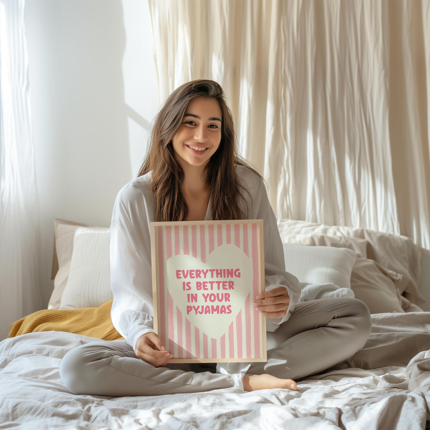 Everything Is Better In Your Pyjamas print, funny pink bedroom wall art featuring a chunky hand drawn quote inside a cream heart on a pink hand painted stripe background, cute cosy bedroom decor poster for above the bed dressing rooms walk in wardrobes and girly interior schemes, perfect thoughtful gift for best friends sisters bridesmaids hen dos Galentines Mother's Day and housewarming, printed on premium 260gsm satin lustre paper, handmade in the UK by Hues and Reflections small business