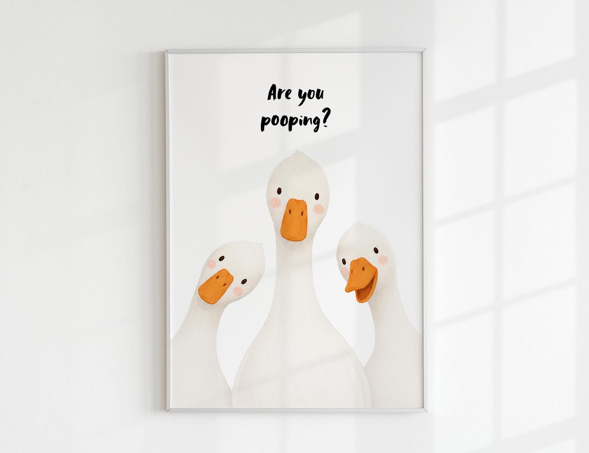 Are You Pooping print, funny bathroom wall art featuring three cute white geese with orange beaks and rosy cheeks on a soft coloured background, whimsical illustrated toilet humour poster also loved as duck art and silly goose art, available in 11 colours including pink jade olive yellow forest green blue sky blonde blue dusk grey claret indigo and white, perfect housewarming gift for powder rooms guest bathrooms and quirky interiors, printed on premium 260gsm satin lustre paper