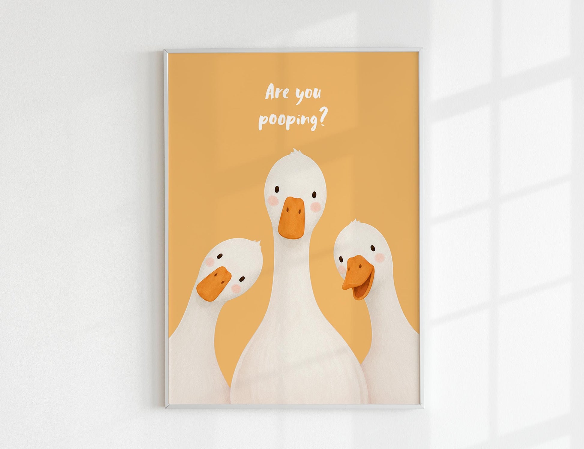 Are You Pooping print, funny bathroom wall art featuring three cute white geese with orange beaks and rosy cheeks on a soft coloured background, whimsical illustrated toilet humour poster also loved as duck art and silly goose art, available in 11 colours including pink jade olive yellow forest green blue sky blonde blue dusk grey claret indigo and white, perfect housewarming gift for powder rooms guest bathrooms and quirky interiors, printed on premium 260gsm satin lustre paper